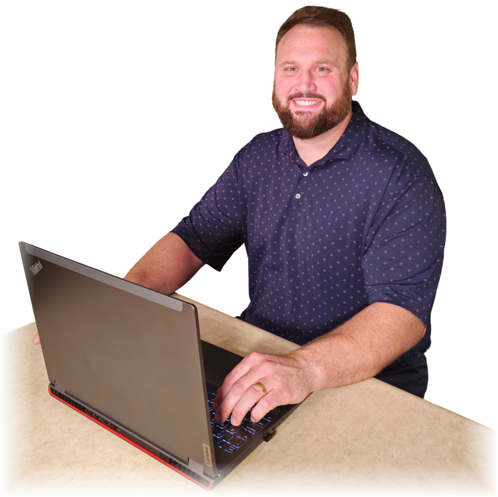 Carl Loser, Founder of StoneBridge Solutions, working at his laptop